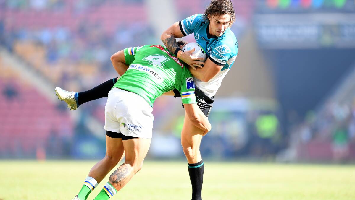 Nicho Hynes of the Sharks is tackled by Sebastian Kris. Picture: Getty