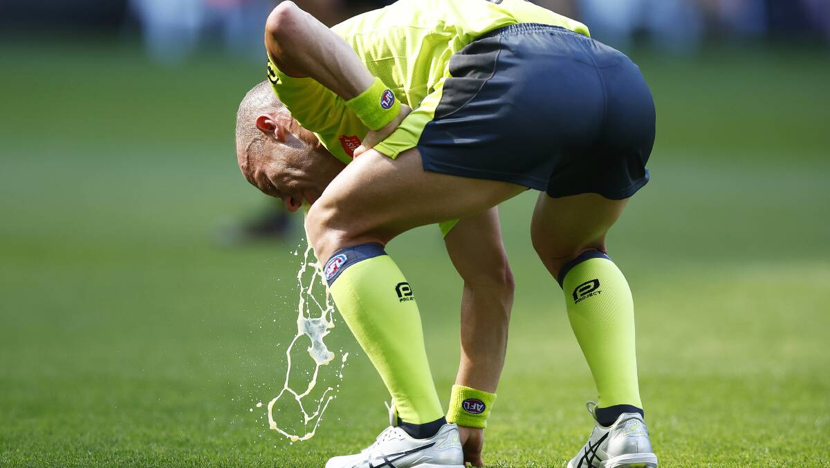 Field umpire Ray Chamberlain vomits on the MCG during the Richmond v GWS match. Picture: Getty Images