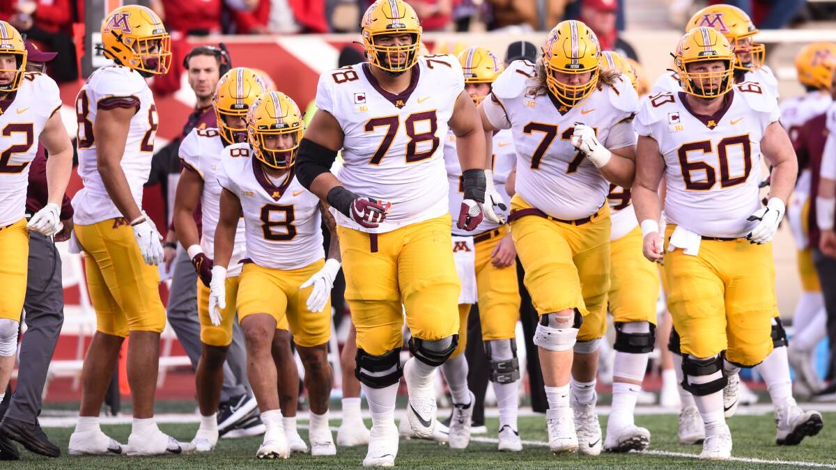 Minnesota's Daniel Faalele (78) leads the offence onto the field during a college football game. Picture: Getty Images