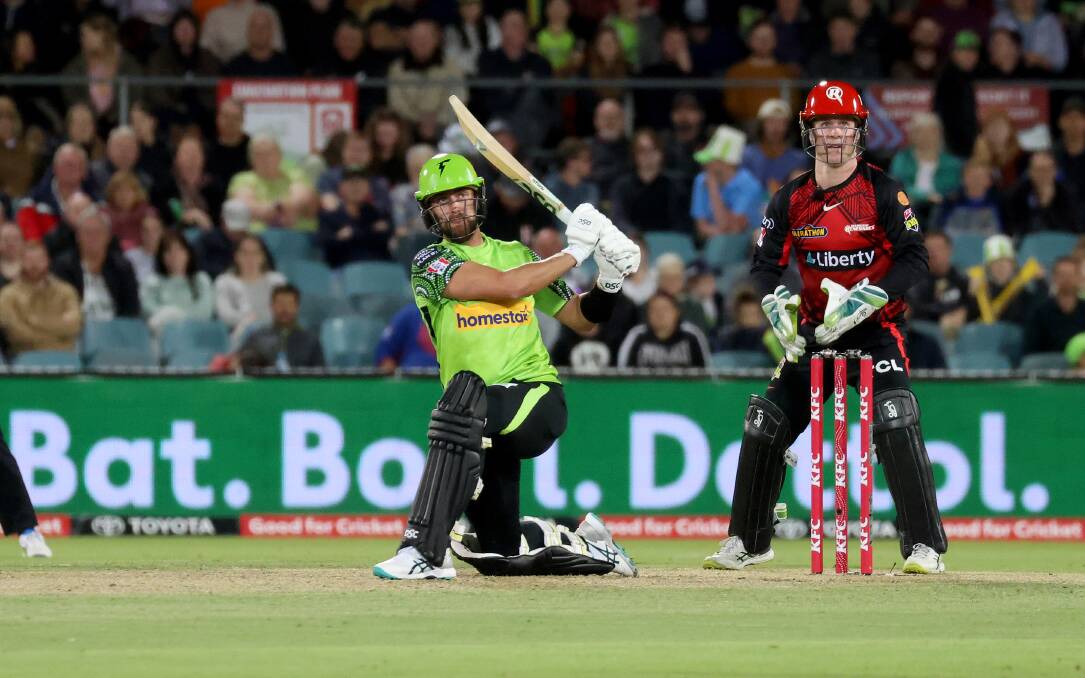 Alex Ross hits a six for Sydney Thunder at Manuka Oval. Picture by James Croucher