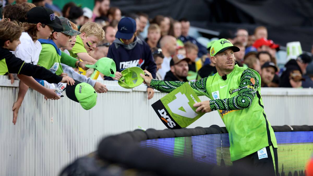 David Warner signs autographs for kids at Manuka Oval. Picture by James Croucher
