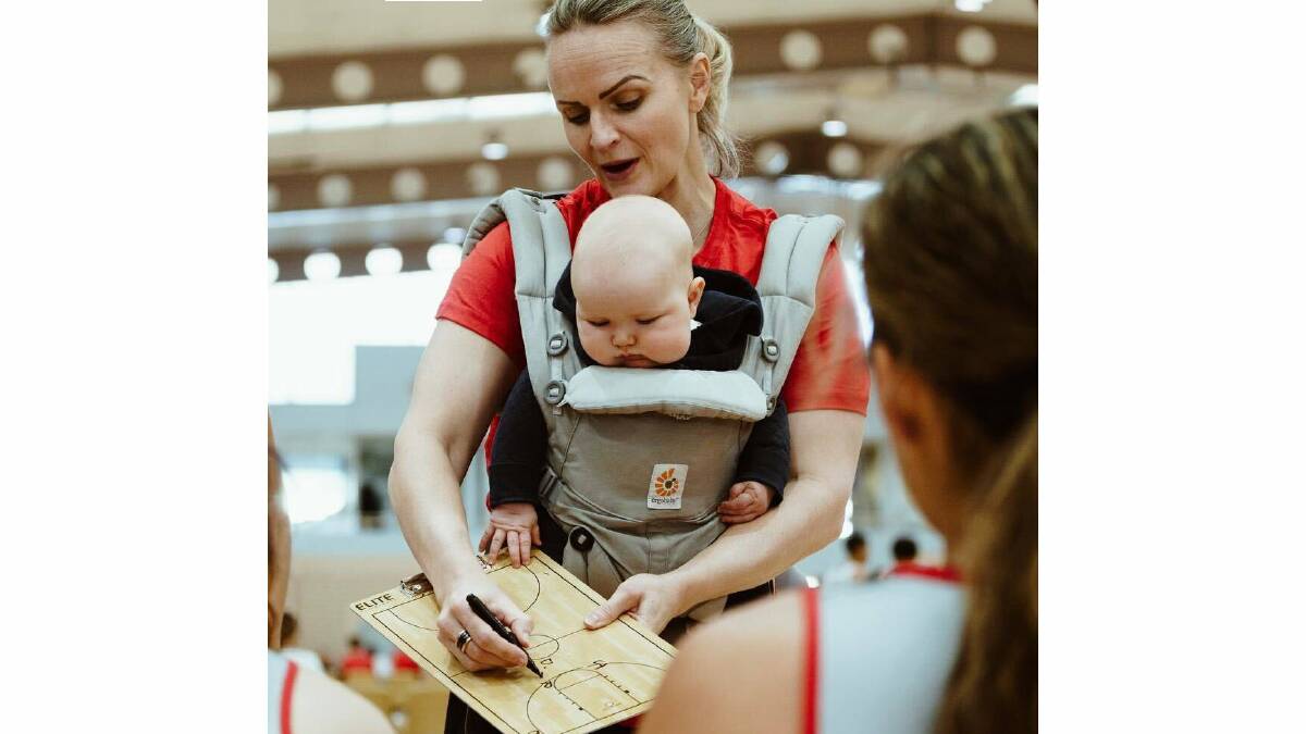 Former Opals star turned coach Jenni Screen with her baby Edith in a carrier.