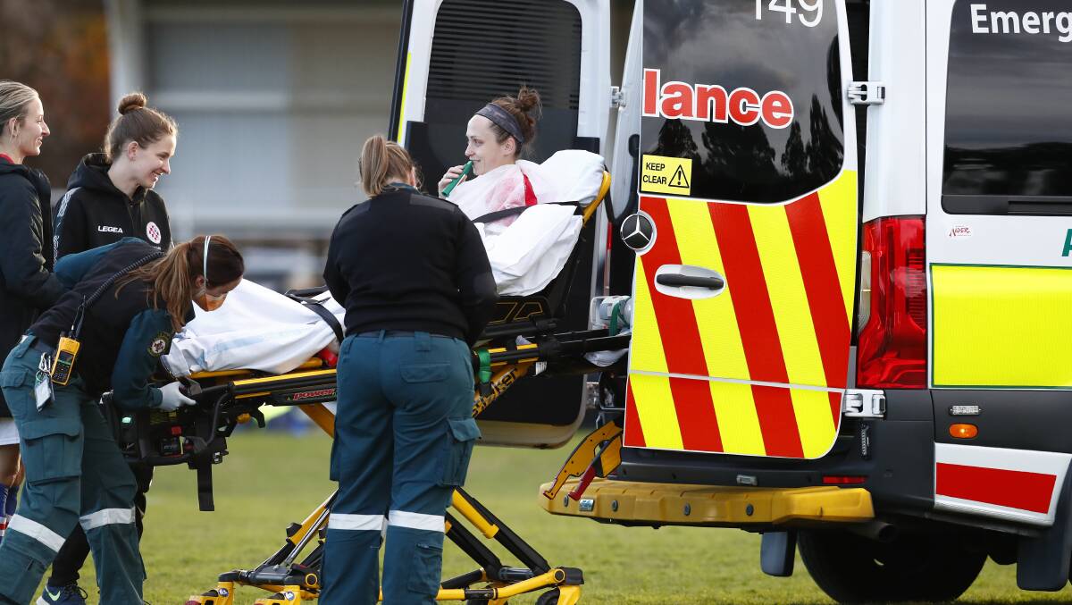 Canberra Croatia's Krista Hagen is stretchered off in an ambulance. Picture: Keegan Carroll