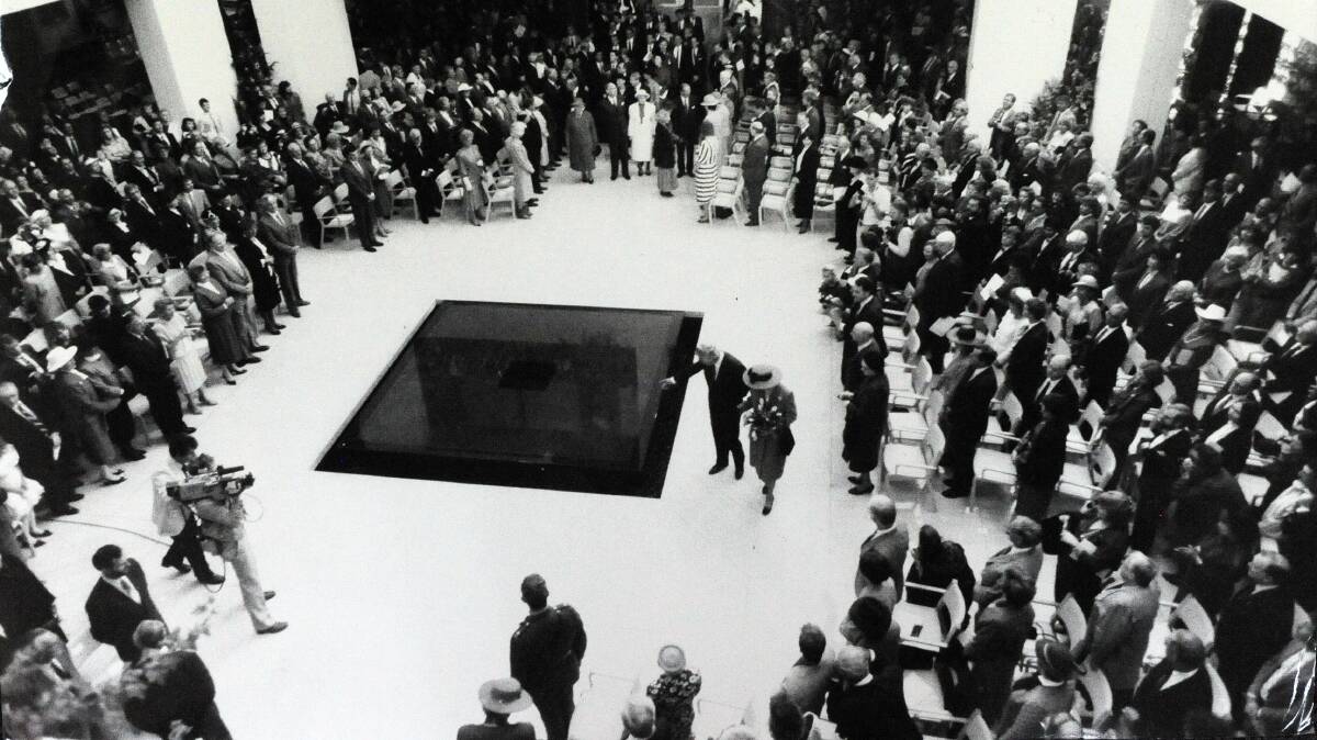 The Queen accompanied by Prime Minister Bob Hawke inspect the reflective pool at Parliament House. 