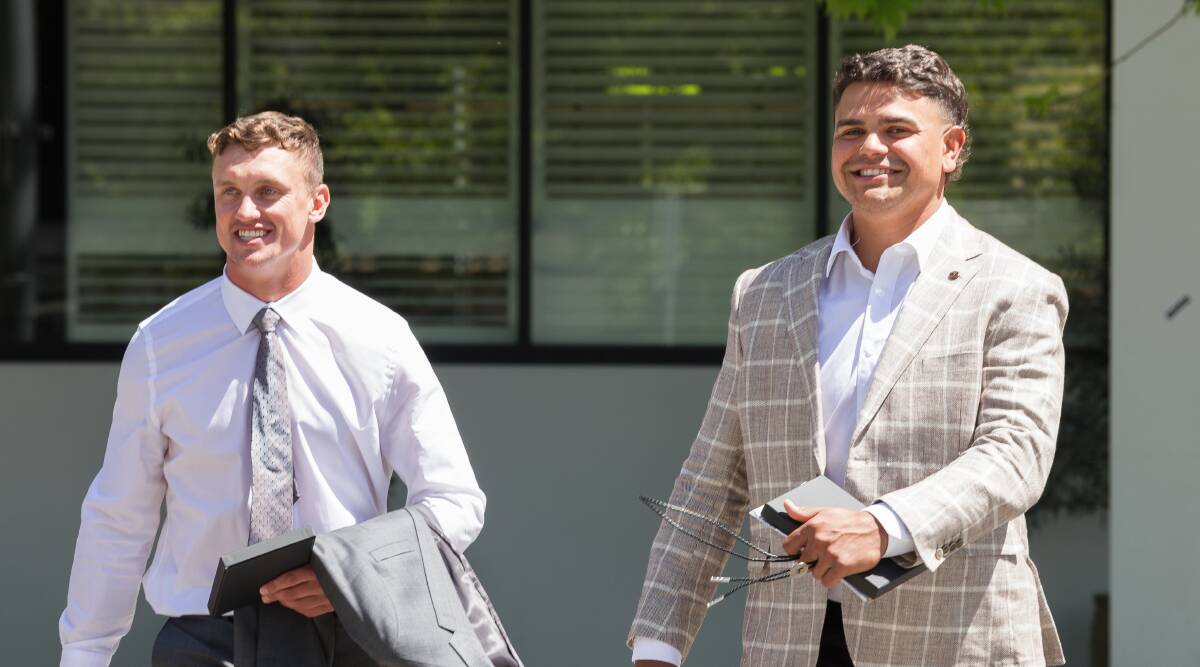 Jack Wighton, left, and Latrell Mitchell, are all smiles after their charges were dismissed on Wednesday. Picture by Sitthixay Ditthavong