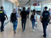 Antony Schuster, who was denied bail, is escorted by police through Canberra Airport. Picture supplied