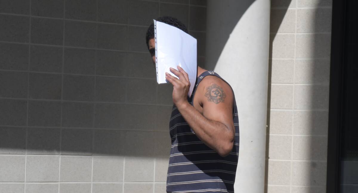 Vishal Sharma hides his face from media cameras after being granted bail. Picture by Tim Piccione 