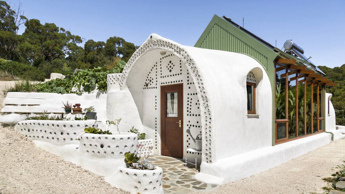 Earthship Ironbank (pictured) used the rammed earth and tyre technology in its walls. Picture supplied. 