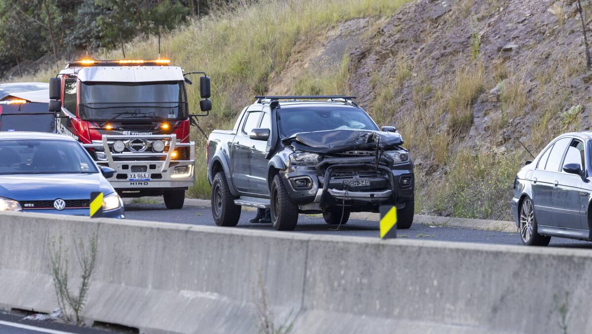 One of the cars in the crash pictured in front of the tow truck called to clear the scene. Picture by The Canberra Times