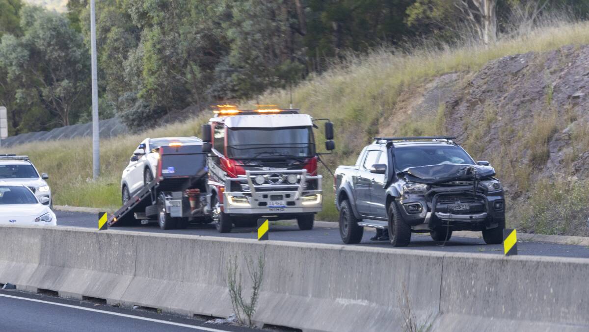 A tow truck cleared up a car crash on Tuggeranong Parkway. Picture by The Canberra Times