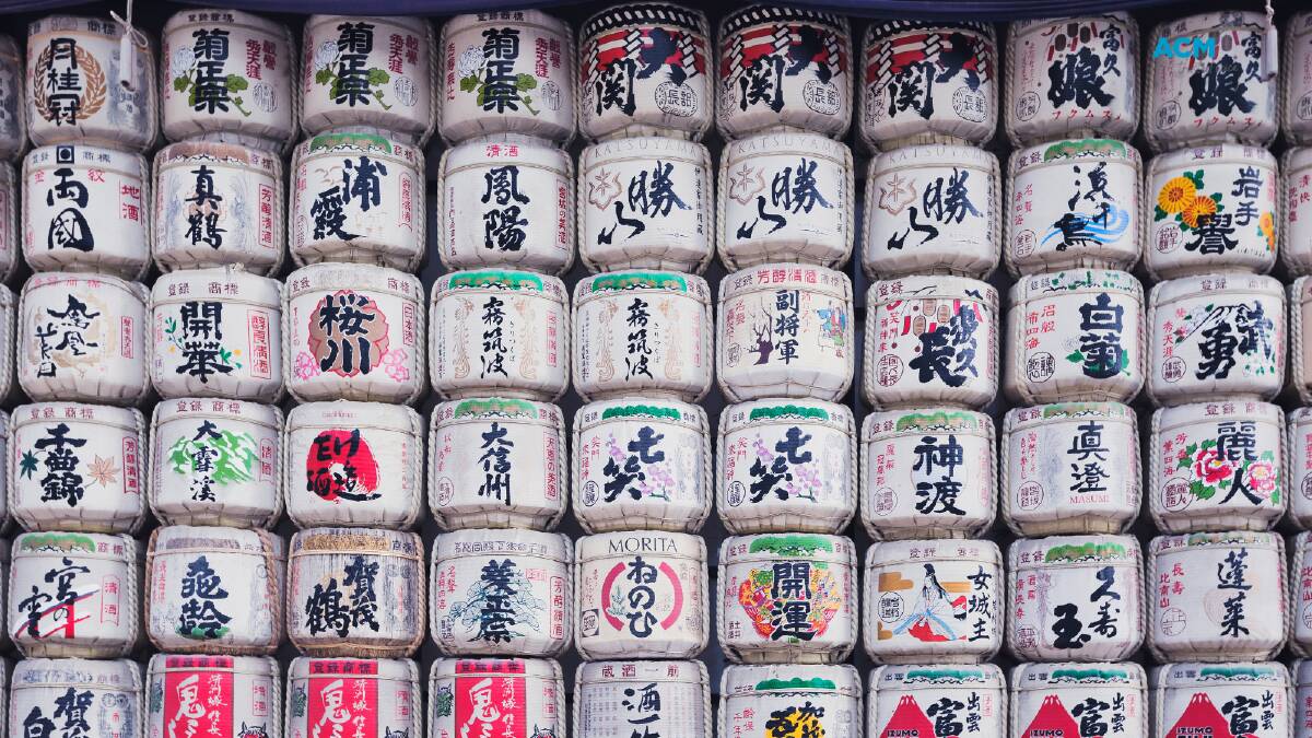 Traditional saké barrels stacked and painted with vibrant colours. File picture.