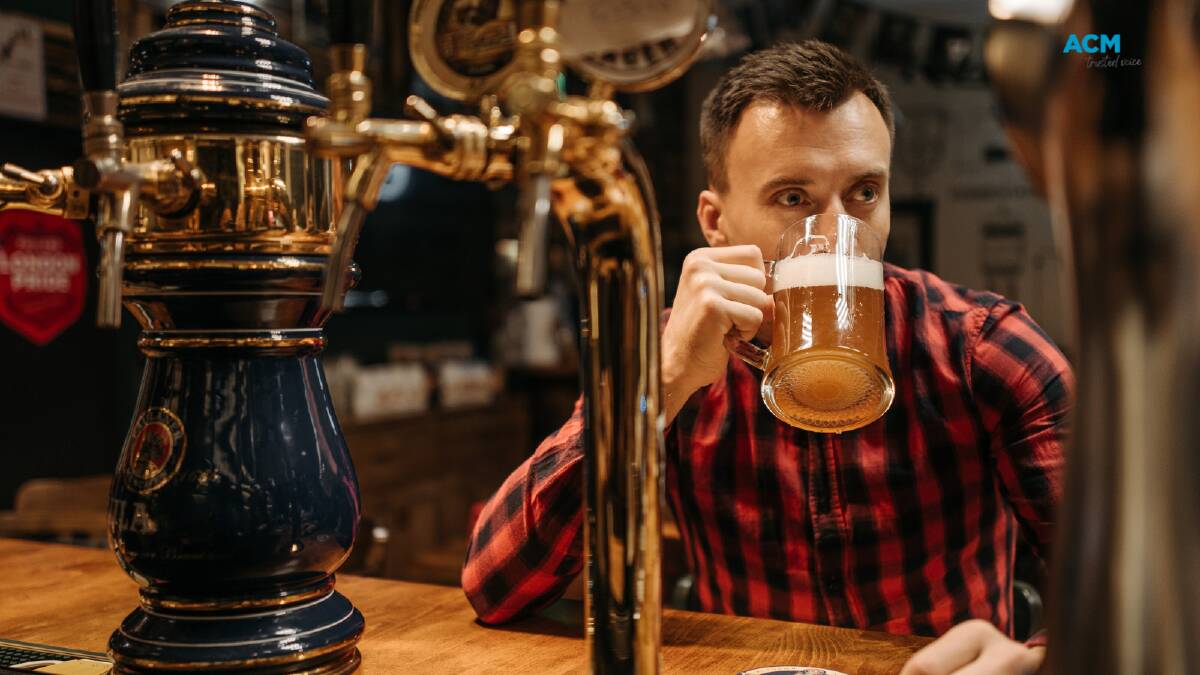 Man sips a stein of beer. Picture via Canva