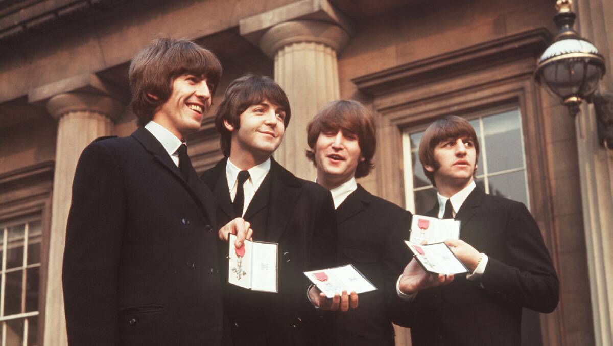 George Harrison, Paul McCartney, John Lennon and Ringo Starr receive MBE awards in 1965. Picture via AP Photos