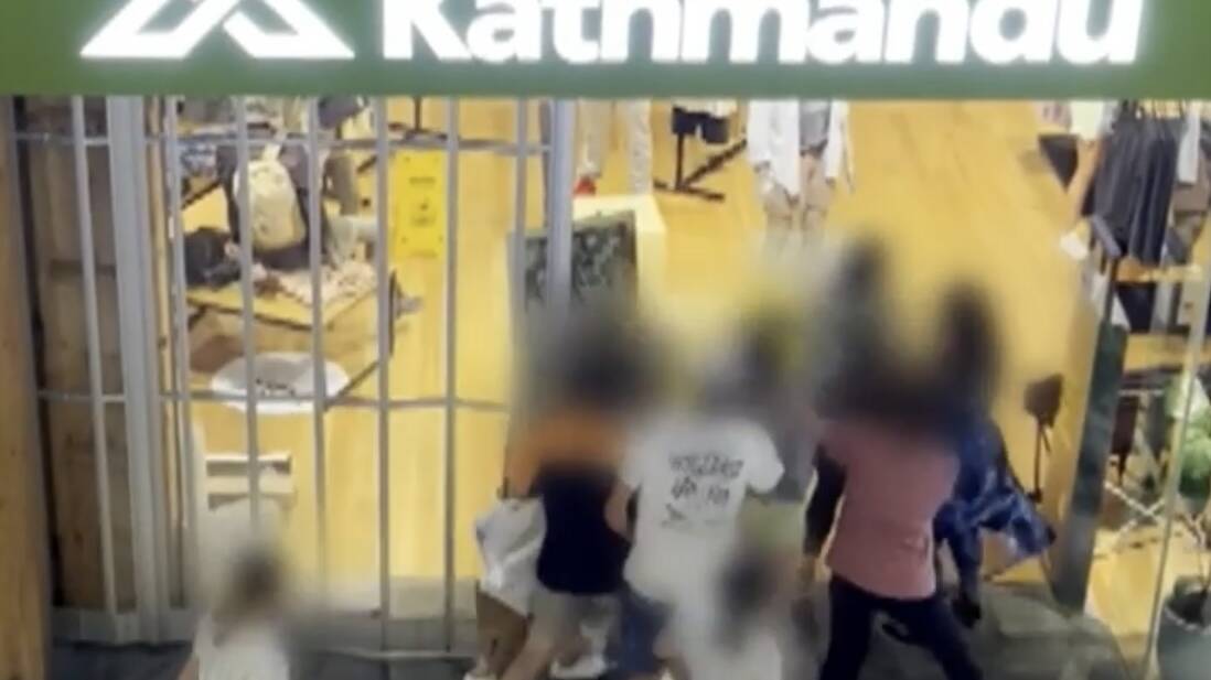 A still image from footage shows the group wrestling in the entry to Westfield's Kathmandu store. Picture by Nine News