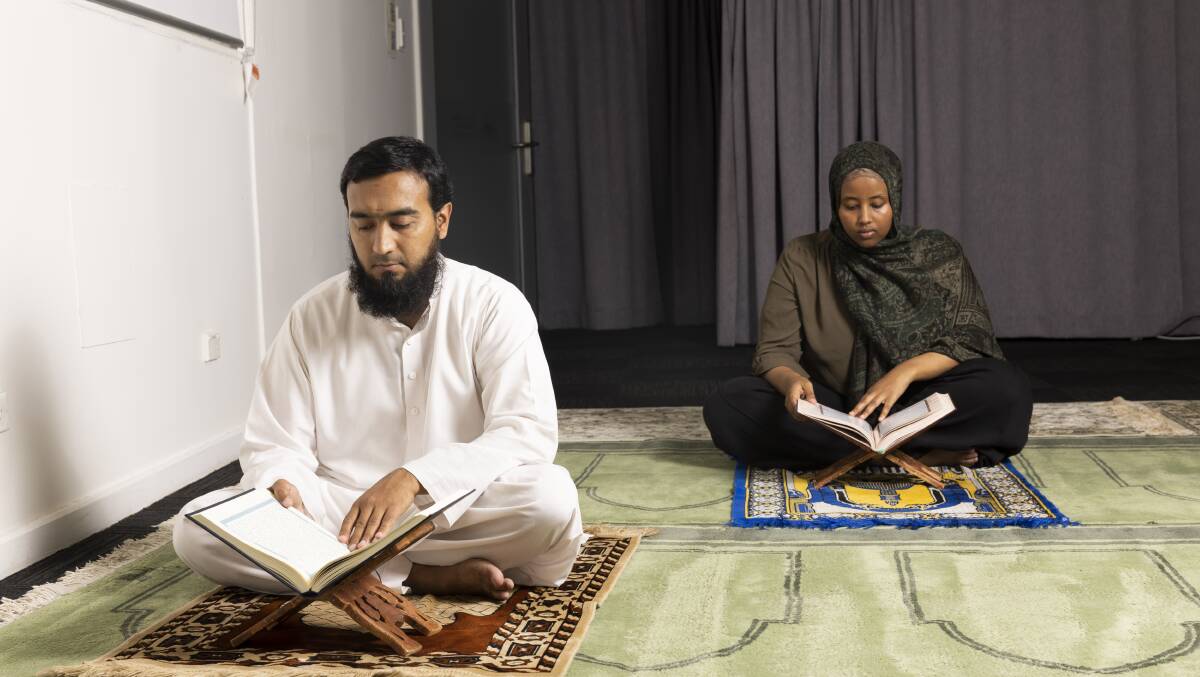 Zain Ul Abideen and Jahan Barkhadle taking a break from the studies with recitation of the Quran in the ANU praying facility. Picture by Keegan Carroll 