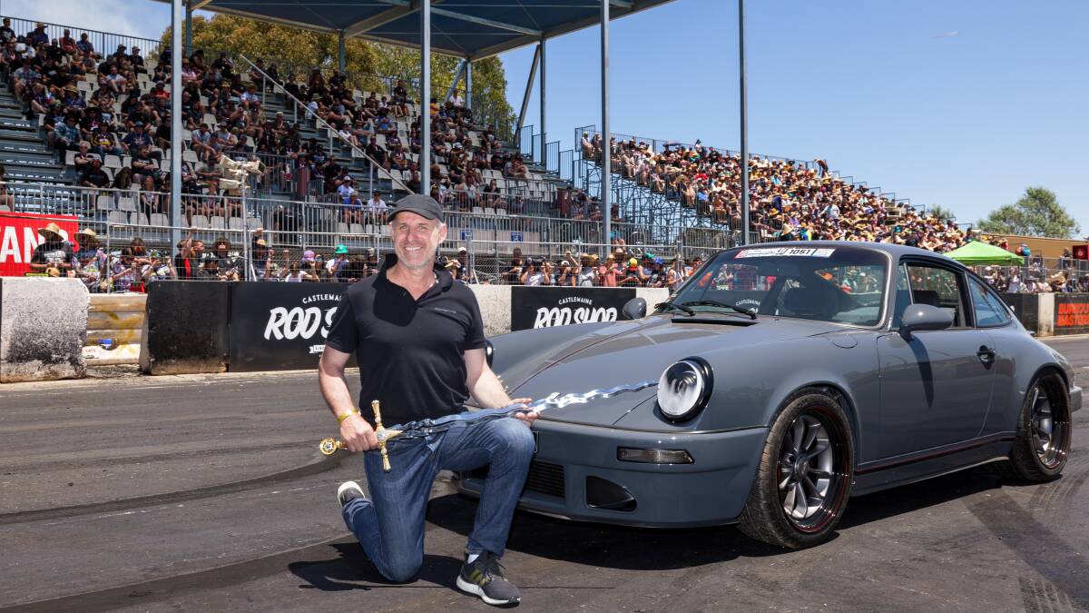 Michelago's Livi Krevatin receives the Chic Henry grand master sword after being announced as Summernats 35 grand champion with his Porsche 911. Picture by Sitthixay Ditthavong 