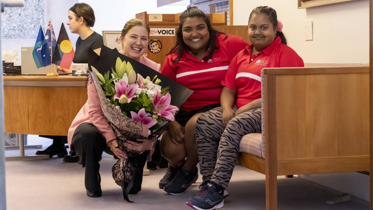Housing and Small Business Minister Julie Collins receives a bouquet from GG's Flowers co-founder Nip Wijewickrema and her sister Gayana. Picture by Keegan Carroll