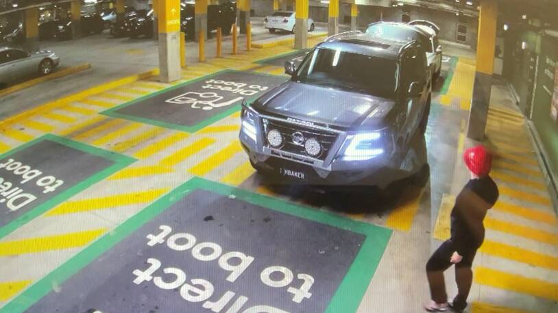 A person is seen approaching the front of the car in a shopping centre car park. Picture by Queensland Police.