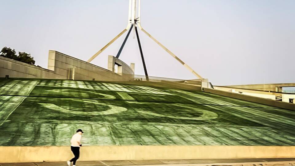 The frost on the lawns of Australian Parliament House on budget day, making the most of the chilly morning to mark the 35 year anniversary of "new" Parliament House. Picture by Karleen Minney