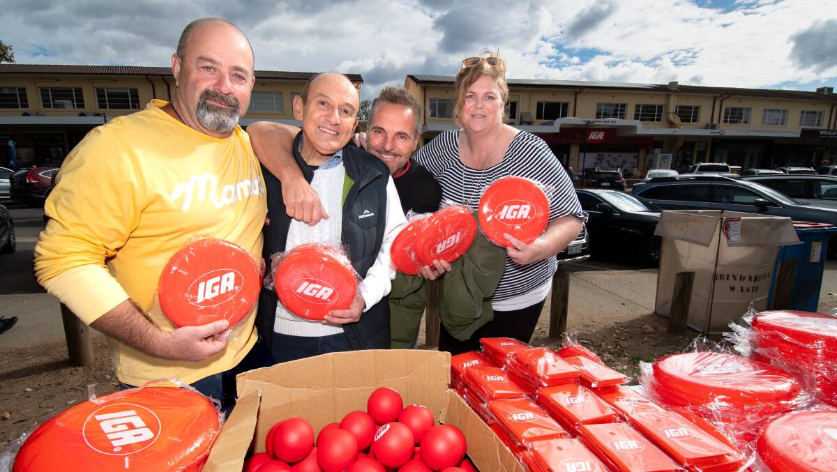 IGA Ainslie owner Manuel Xyrakis, second from left, celebrates the store's 60 years of operation with former employees Tony Gelonesi, Tony Giampaolo, and Cath Day. Picture by Sitthixay Ditthavong