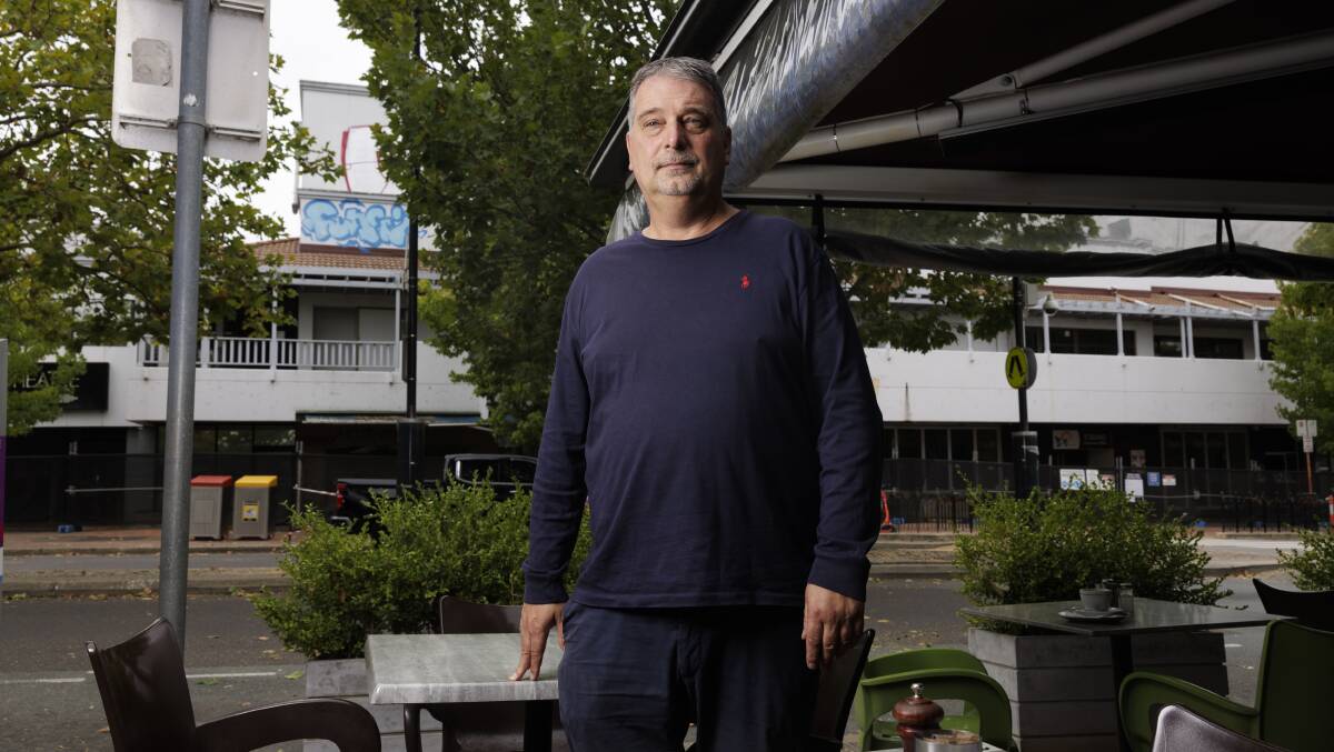 Owner of Caph's Manuel Notaras has seen Manuka change over the years but needs the old cinema over the read to be fixed to bring more customers in. Picture by Keegan Carroll