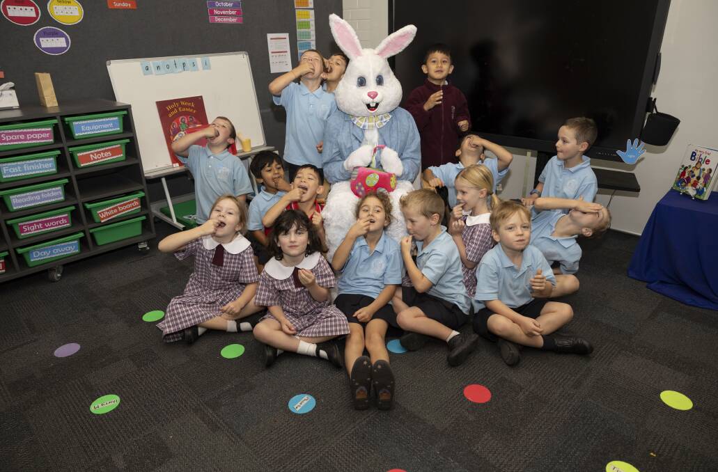 The principal of Sacred Heart Primary School in Pearce, David Austin, dressed up as the Easter Bunny to entertain the playgroup kids aged 2, 3, and 4.
