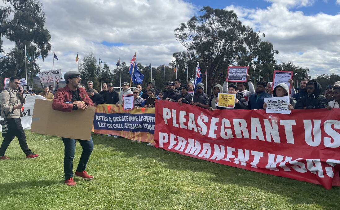 Hundreds gathered in front of Parliament House on Tuesday to call on the government to grant 12,000 asylum seekers permanent visas. Picture by Natalie Vikhrov. 