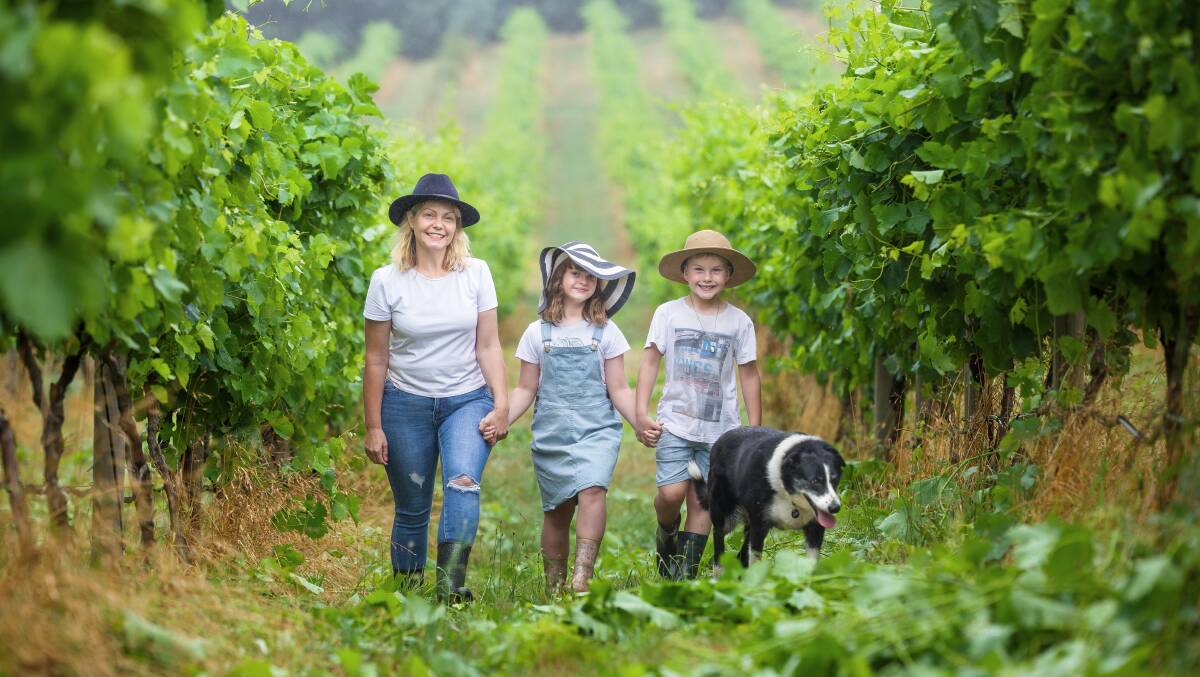 Lake George Winery owner Sarah McDougall with children Eloise, 7, and Ryder, 6, with Pepper the dog. Picture by Sitthixay Ditthavong
