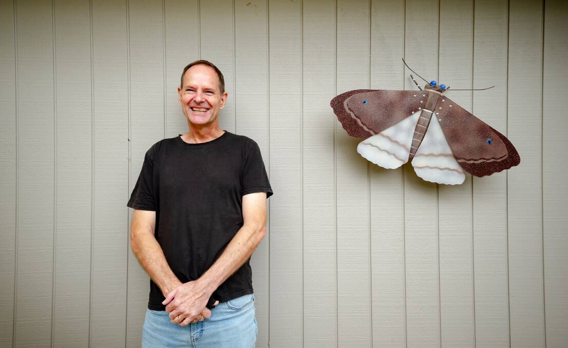 David Smith with one his works, a bogong moth. Picture by Elesa Kurtz