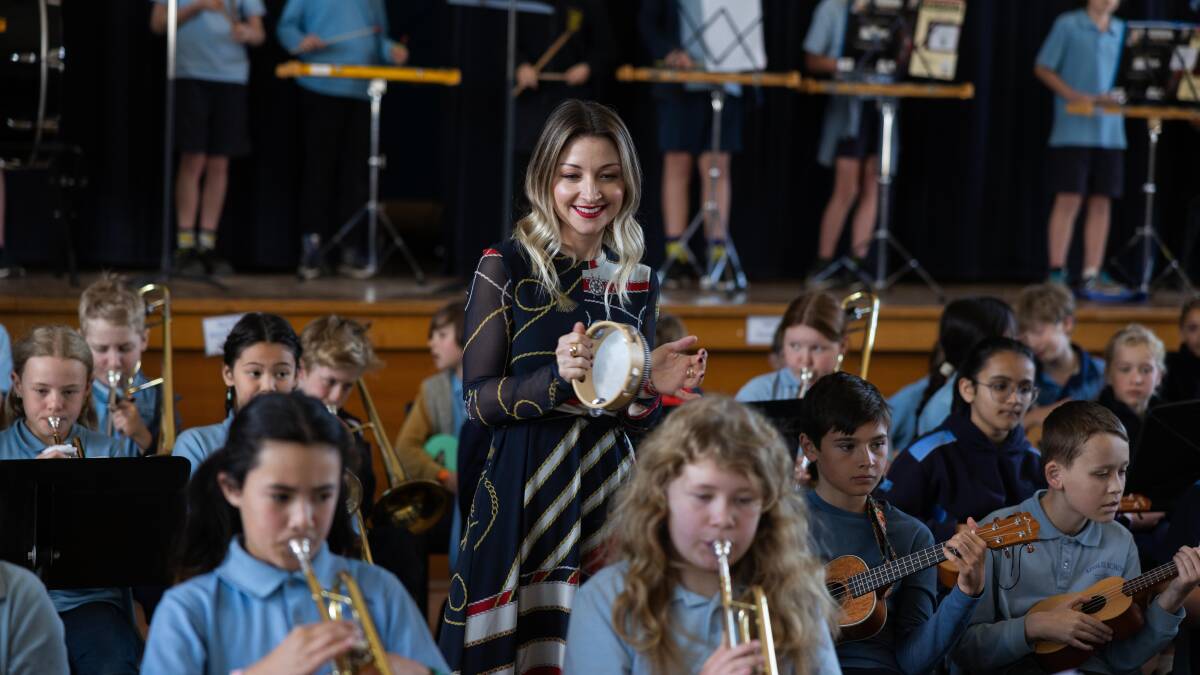 Kate Miller-Heidke even conducted the orchestra at Ainslie School during her visit. Picture supplied 