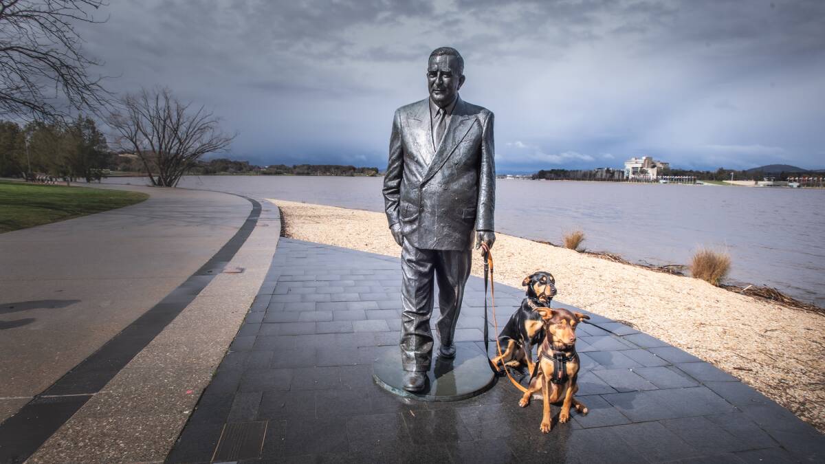 Members of the public often playfully interact with the statue of Sir Robert Menzies on the shores of Lake Burley Griffin. Picture by Karleen Minney