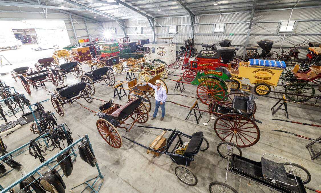 The astounding collection of horse-drawn carriages owned by the late Peter Keir. His son Paul is pictured with the collection. Picture by Sitthixay Ditthavong