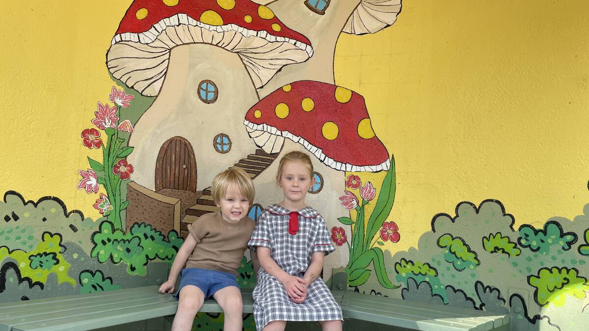 Wyatt, 3, and Heidi Welder, 5, in the Torrens bus shelter painted by "Mr McGregor". Picture by Megan Doherty