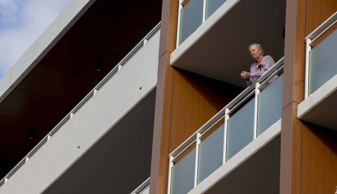 Birthday boy Richard Gray watches the concert from his balcony. Picture: Sitthixay Ditthavong
