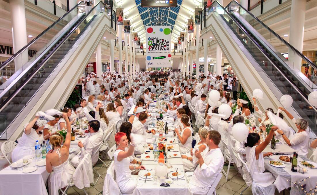When Diner en Blanc was rained out at Rond Terrace in 2014, patrons were bussed to the Canberra Centre to continue the event indoors. Picture by Katherine Griffiths