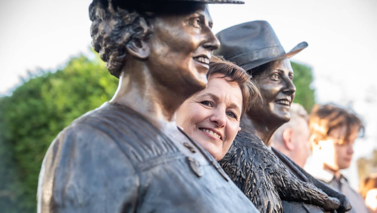 Sculptor Liz Johnson with her work showing the first woman elected to parliament, Dorothy Tangney (left) and Enid Lyons. Picture by Karleen Minney