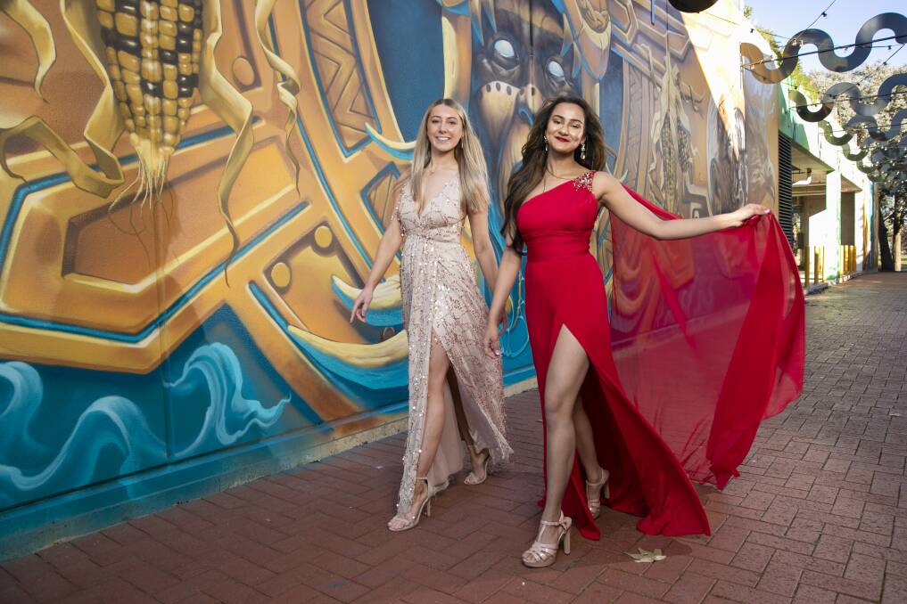 The ACT's Miss World contenders Lydia Harland and Krishna Shukla strut their stuff against the new Malabar Lane murals in Dickson. Picture: Keegan Carroll