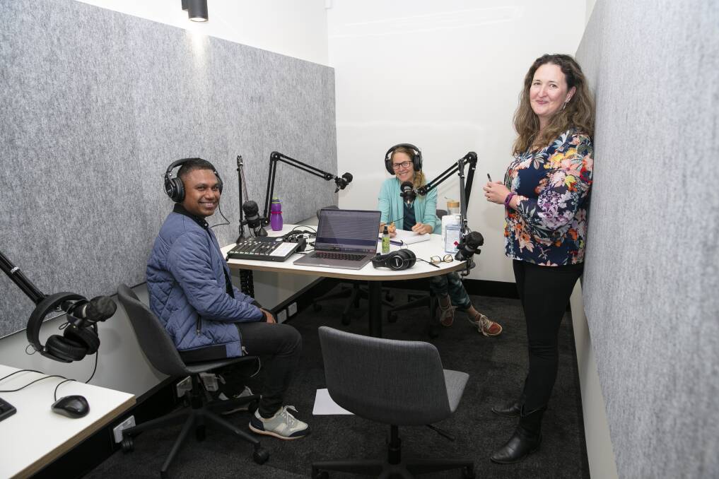 Jen Seyderhelm (standing) teaching podcast technique to Shui Kabir and Suzanna Thell at the Woden Library open day. Picture: Keegan Carroll,
