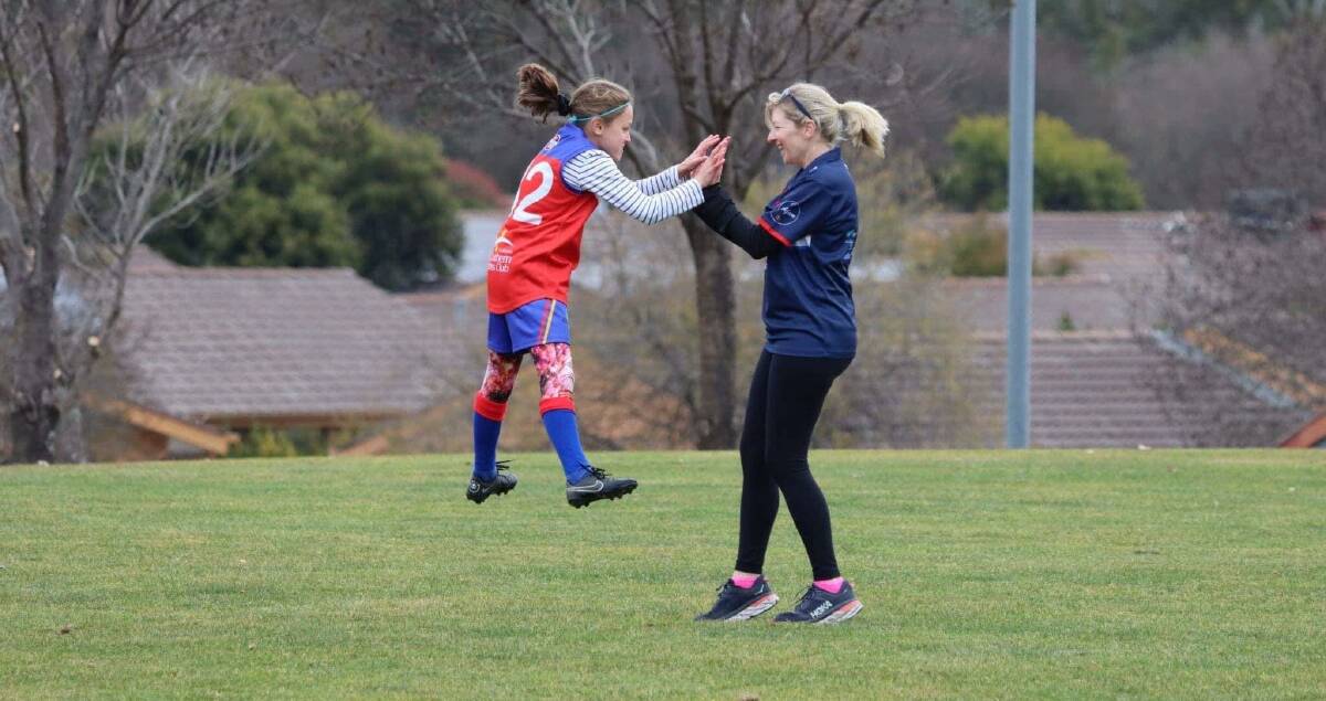Coach Eugenie Hickey and player Alyssa Keeffe celebrate a goal in a photograph that has gone viral. Picture: Luke Hickey