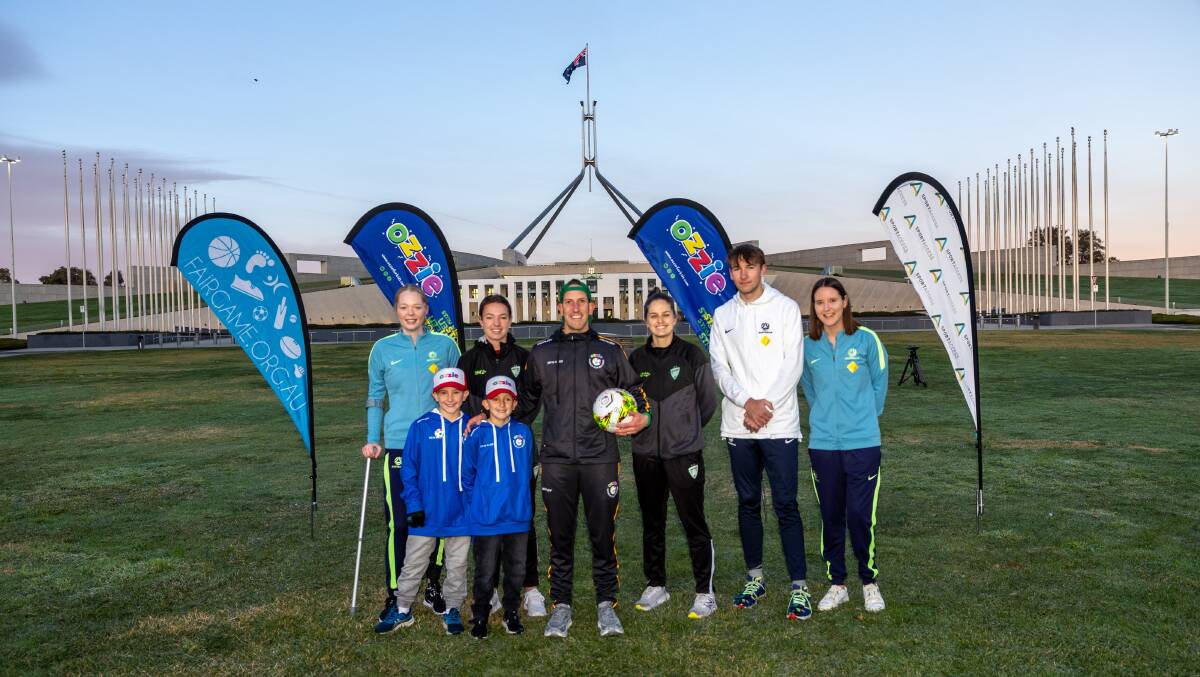 Scott "Ozzie" Richmond (centre) at Parliament House on Friday morning with children Channing, 10, and Fraser, 7, and (l--r) Bec Jones from the ParaMatildas, Grace Maher and Ellie Brush from CanberraUnited, Luc Launder from the Pararoos and Carly Salmon from the ParaMatildas. Picture by Gary Ramage