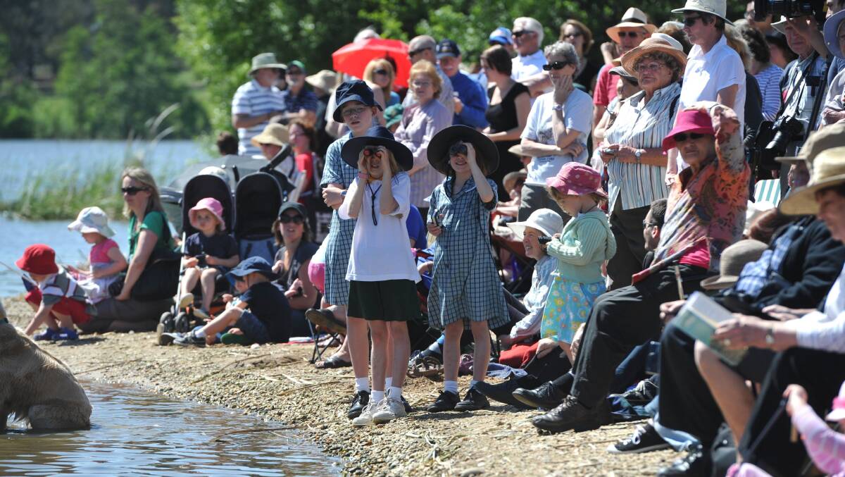 Part of the crowd that gathered on the shores of Lake Burley Griffin in 2011 to watch the Queen and Prince Philip sail from Government House to Floriade. Picture by Graham Tidy