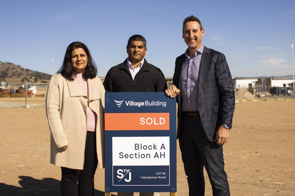 The first official buyers at the South Jerrabomberra housing estate, Sharzreena and Rahimat Ali, with Village Building Company chief executive Travis Doherty. Picture: Keegan Carroll