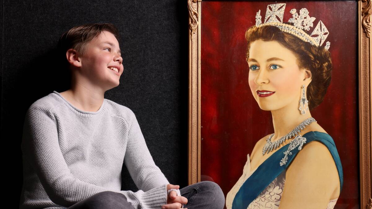 William Clayton, 12, of Nichols, with a portrait of Queen Elizabeth II. He met her as a two-year-old when she visited Canberra in 2011. The 27th birthday portrait of Her Majesty, now owned by Ilona Purcell, is also in the Queen and Me exhibition. Picture: James Croucher