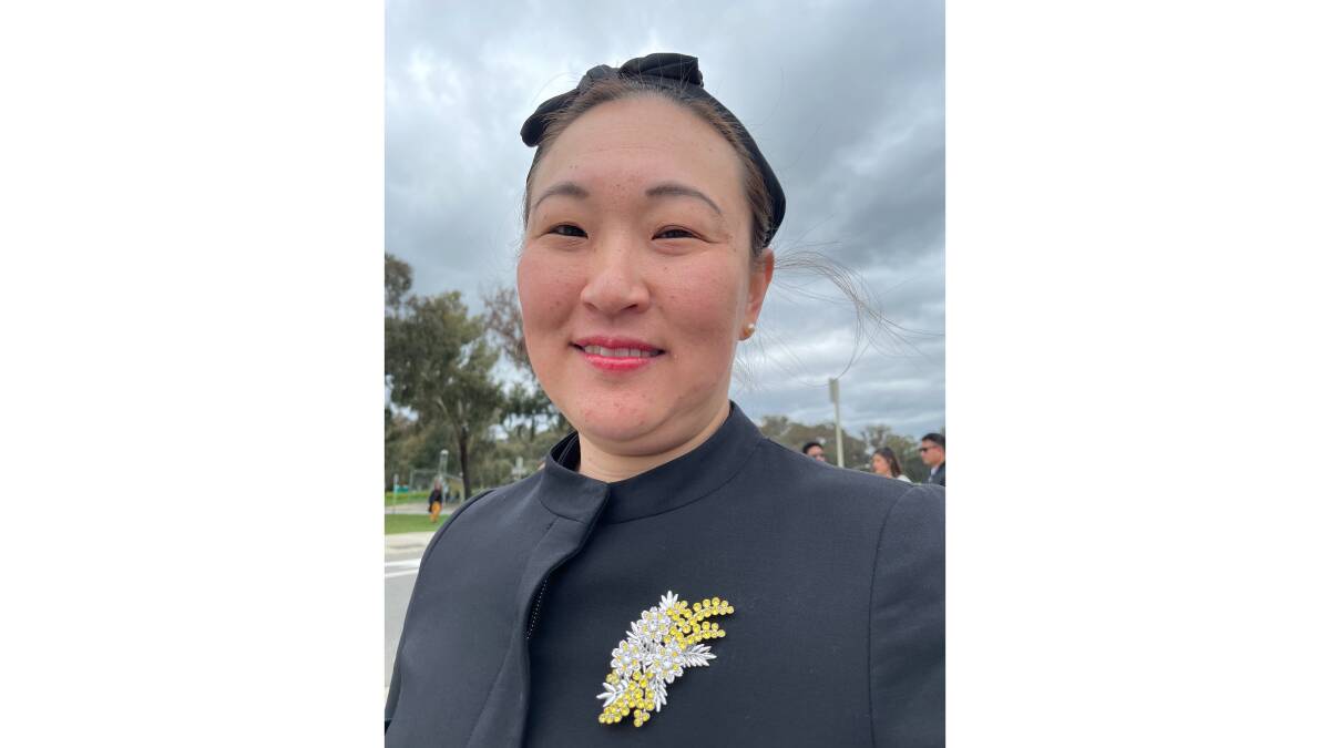 Vanessa Cheng, of Sydney, attended the service wearing a replica of the Queen's wattle brooch. Picture by Megan Doherty