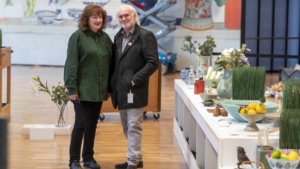 Artist Cressida Campbell and husband Warren Macris with the blown-up 'The kitchen shelf' in the background. Picture by Keegan Carroll