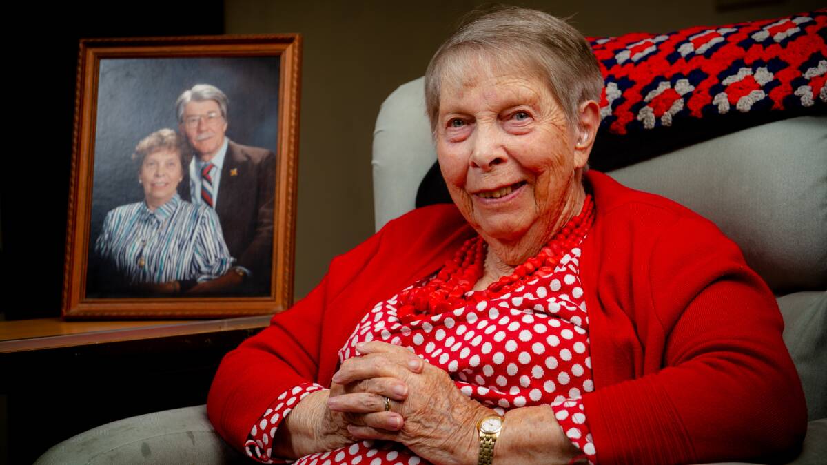 Dorothy Hine at home in Yarralumla with a photograph of her husband Warren, who passed away in 2018 aged 95. Picture: Elesa Kurtz
