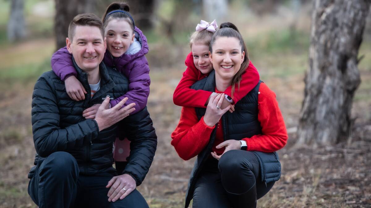 Ashley Clifford, 9, (left) with dad Hugh and mum Belinda and sister Sophie, 6. Picture by Karleen Minney