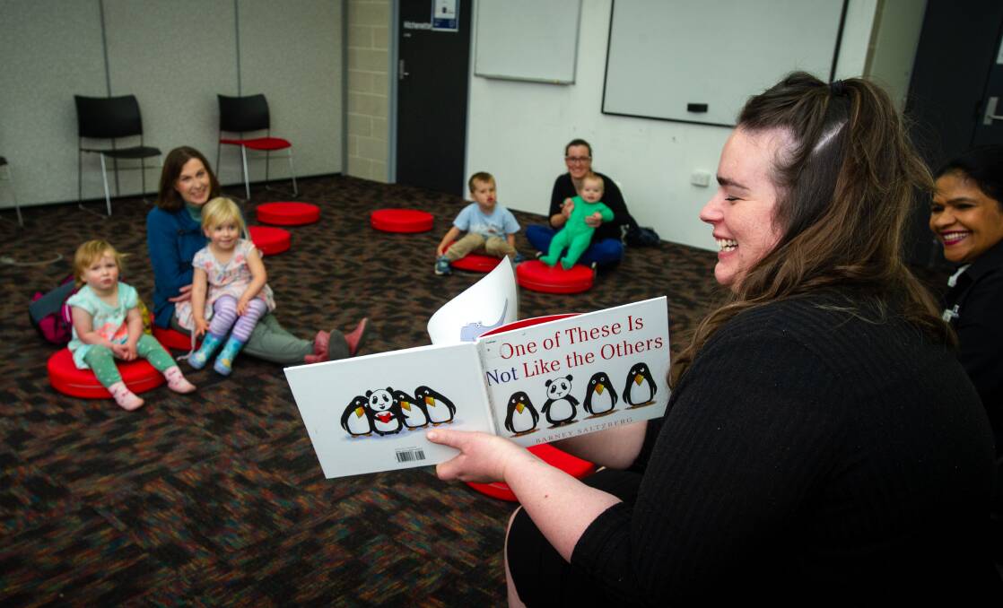 Jeanette Cotterill with grandchildren Eva, 3, and Molly Miller, 1, and Karina Harding with Rhys, 5, and Linnea Molineux, 9 months, enjoying Story Time back at the Gungahlin Library with early literacy champion Emily Chinn. Picture: Elesa Kurtz