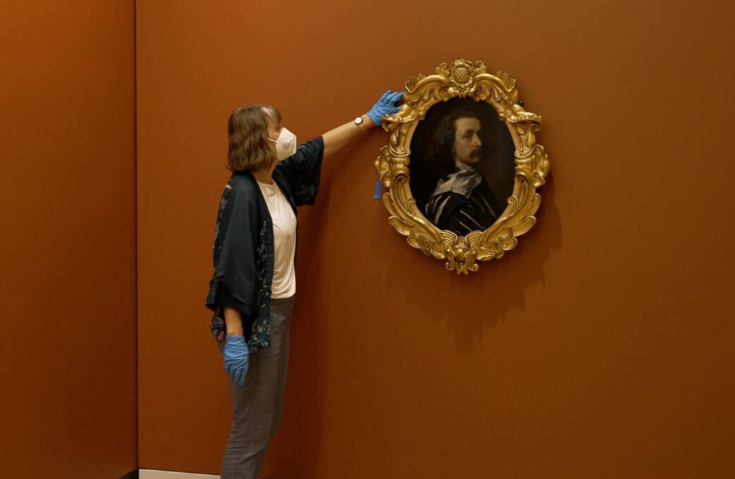 Frame conservator Stephanie Carlton at the National Portrait Gallery in Canberra with Self portrait c. 1640 by Sir Anthony van Dyck. Picture: Mark Mohell