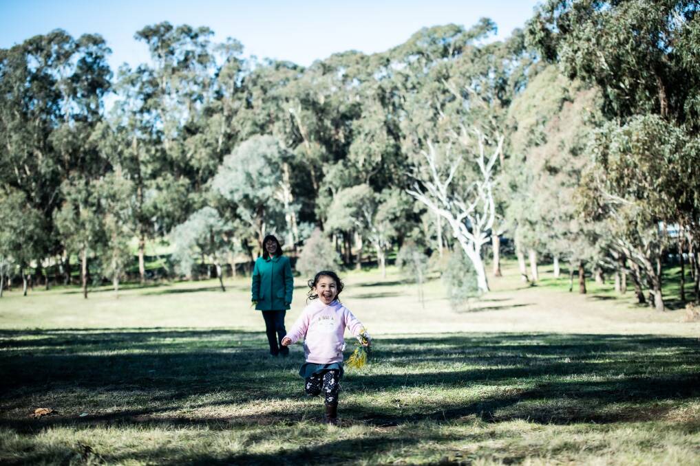  Garran resident Mari Kondo, with her daughter Ellen, four, on urban open space likely to be bulldozed for a road to the proposed retirement village. Picture: Karleen Minney
